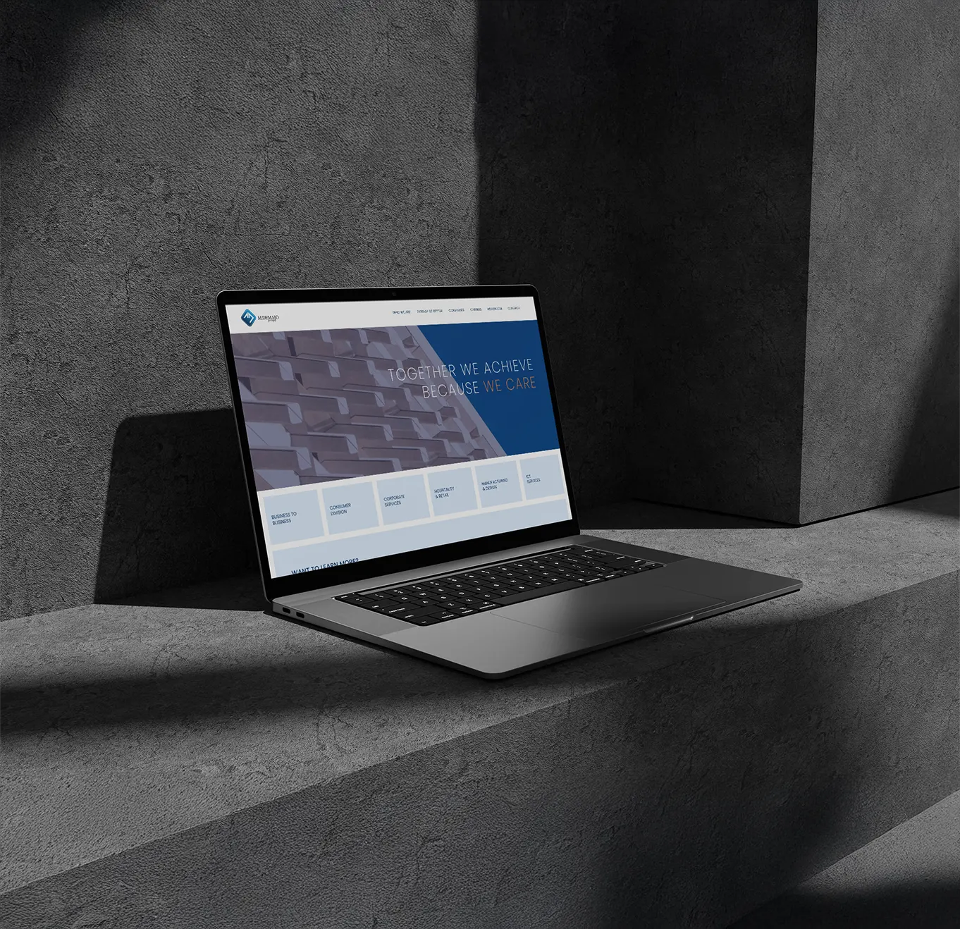 M. Demajo Group corporate website on a laptop, built by Haystack