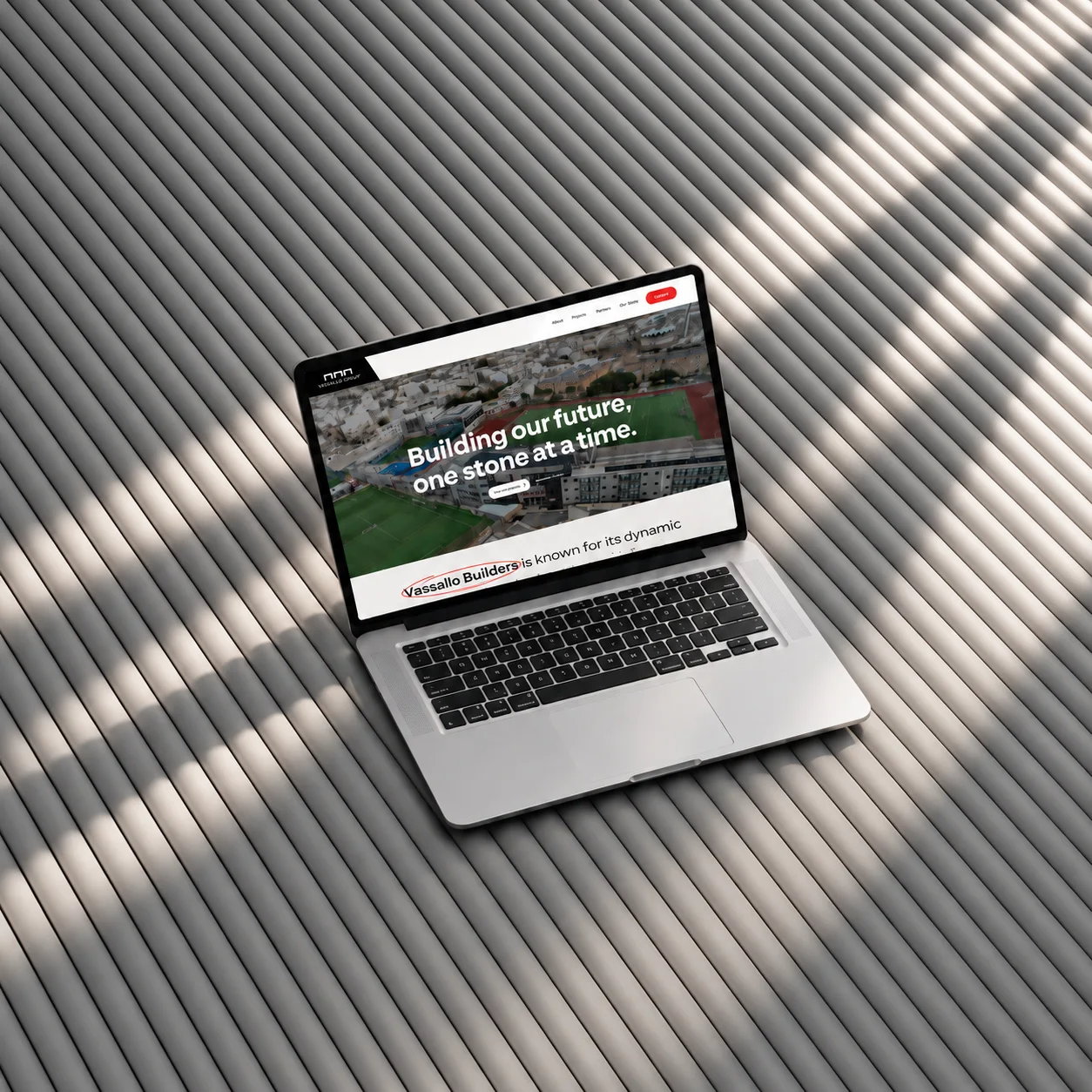 Vassallo Builders website on a laptop showing Building our future, one stone at a time, built by Haystack